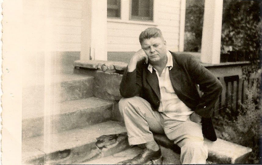 A man sitting on the steps of a house.